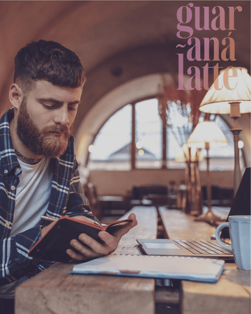 Focused man enjoying Vallentine & Co Guaraná Latte in a calm café setting