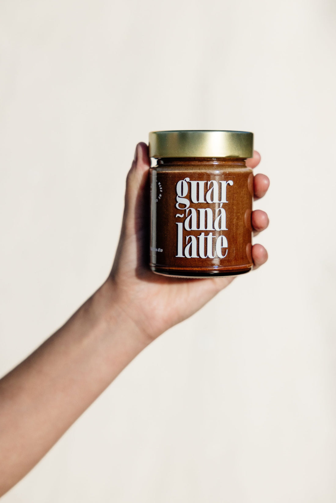 Vallentine & Co Guaraná Latte single jar held against a light backdrop